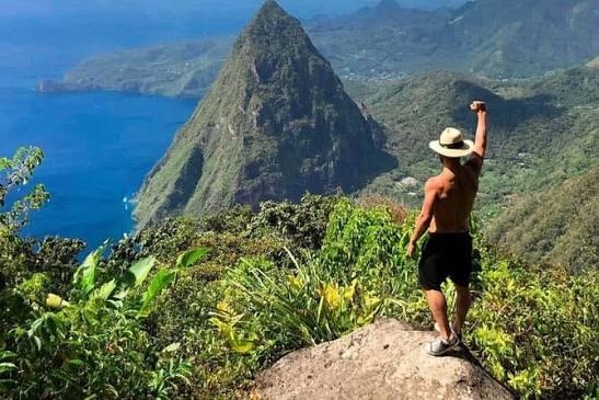Hiker celebrating at Piton summit, Saint Lucia
