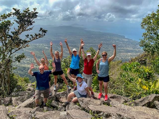 Group celebrating at mountain overlook, Saint Lucia